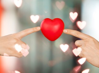 Happy volunteer holding red heart, promoting charity, donation campaign