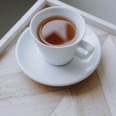 Glass of tea on board with herring bone pattern 