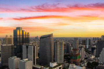 Fototapeta na wymiar Aerial view of modern office buildings in Bangkok downtown with sunrise time, Bangkok, Thailand