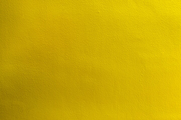 Yellow color with an old grunge wall concrete texture as a background.