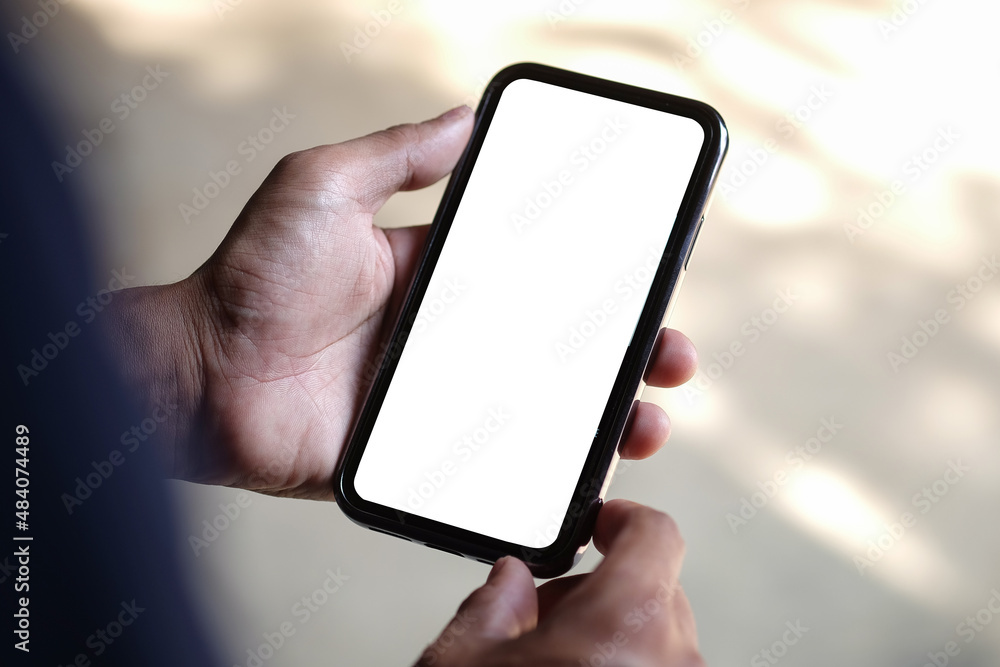 Poster young man holding mockup smart phone with empty screen. close up..