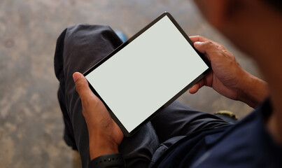 Young man using digital tablet. Blank screen for your text..