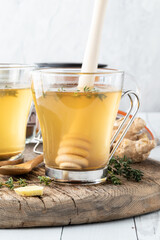 Close up view of a healing medicinal tea with thyme and ginger.