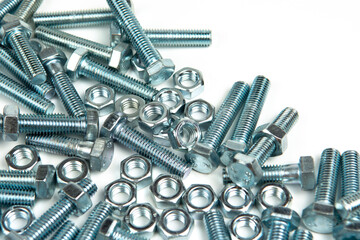 several silver metal bolts with nuts on a white background. close-up and copy space