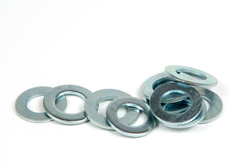 several silver metal washers on a white background. close-up