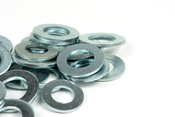 several silver metal washers on a white background. close-up
