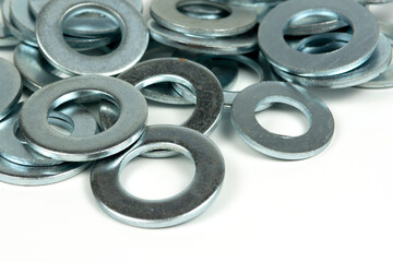 several silver metal washers on a white background. close-up