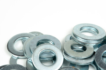 several silver metal washers on a white background. close-up