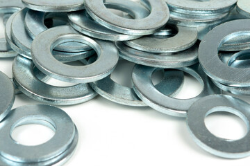 several silver metal washers on a white background. close-up