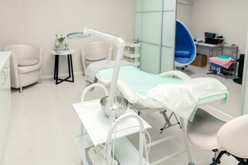 Cosmetologist empty office with care cosmetics and massage table in a modern beauty salon.