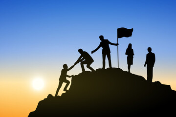 Silhouette of people helping each other hike up a mountain at sunrise. Business, teamwork, goal, success and help concept.