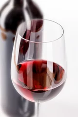 Fotobehang glass of red wine and bottle on white background © luchschenF