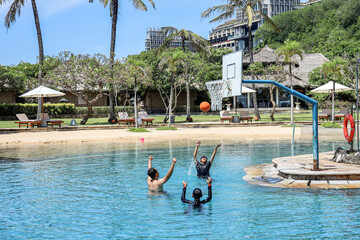 Play with family. Play basketball in the pool. vacation with family. Celebration of getting the...