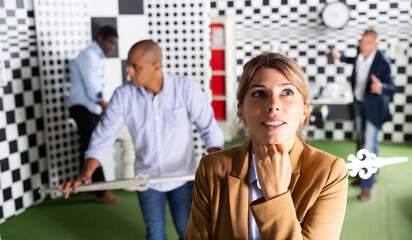 Young emotional woman having good idea solving puzzle to get out of quest room