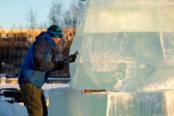 Portrait of a sculptor at work on a figure