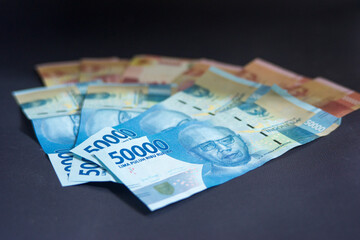 Indonesian rupiah currency on a black background. Good for economy concept. Coin Illustration. fiat money. fifty thousand rupiah