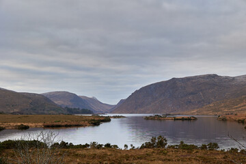 Glenveagh National Park, Co. Donegal. view of lake between mountains. Mountain scene with cloudy sky.