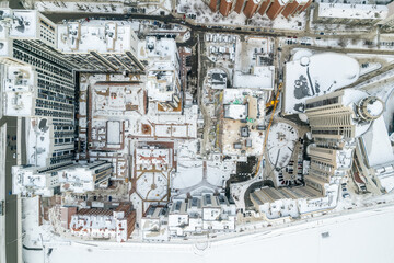 Aerial drone view of the city at winter, with houses and roads. Winter landscape
