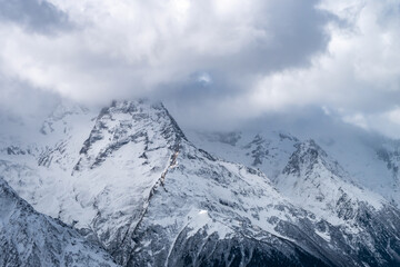 Obraz premium Mountain top surrounded by clouds. Greater Caucasus ridge
