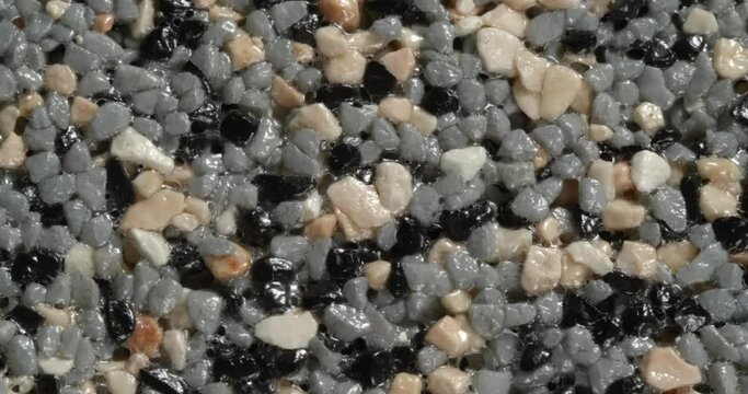 Close-up texture of fine marble chips. Grey and black and beige color.