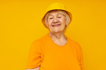 smiling elderly woman happy lifestyle in a yellow headdress yellow background