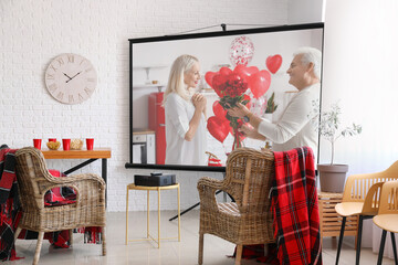 Scene of romantic movie on screen of video projector at home