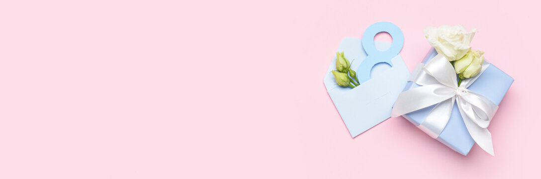 Gift box with flowers and envelope for International Women's Day on color background with space for text