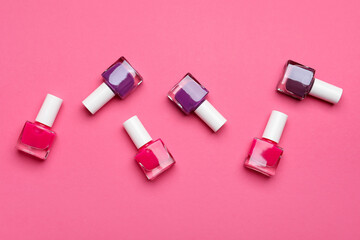 Set of nail polish bottles on color background