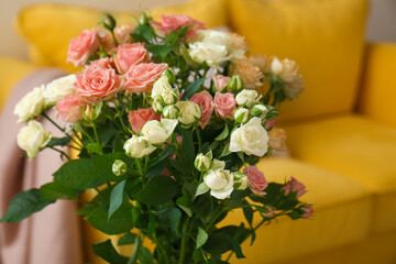 Bouquet of beautiful fresh roses in room, closeup