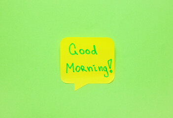 Sticky note with text GOOD MORNING on green background