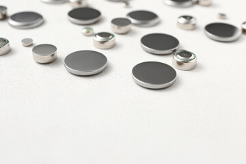 Metal lithium button cell batteries on white background, closeup