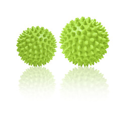 Two green spiny massage balls isolated on white. Concept of physiotherapy or fitness. Closeup of a colorful rubber ball for dog teeth on a white color background. Corona virus model. Snowflake.