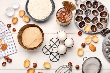 Fresh ingredients for preparing walnut shaped cookies with boiled condensed milk on white wooden background