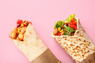 Delicious burritos on pink background