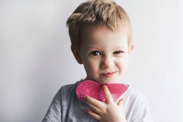 little emotional, smiling child with a pink heart - 484093825
