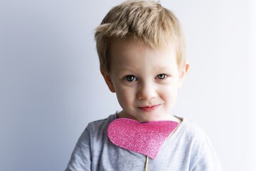 little emotional, smiling child with a pink heart - 484093846