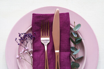 Stylish table setting and flowers on light wooden background