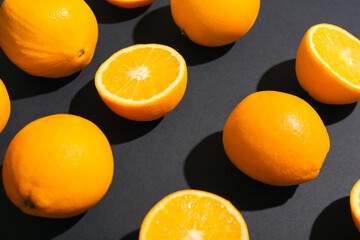 Fresh cut oranges on dark background, closeup