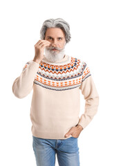 Fototapeta premium Handsome senior man in knitted sweater on white background