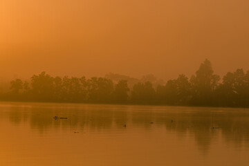 Fototapeta premium The background of the sea by the evening sea, with natural beauty (sea water, rocks, sky) and fishermen are fishing by the river bank, is a pleasure during travel.