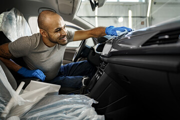 A man cleaning car interior, car detailing in Carwash service
