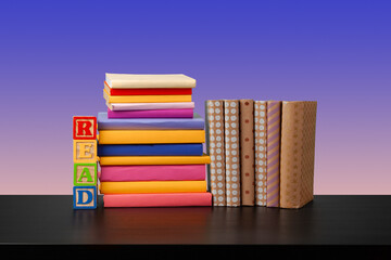 Stack of books on black wooden table