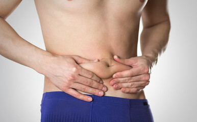 Naklejka premium Weight loss. A man with overweight on his stomach