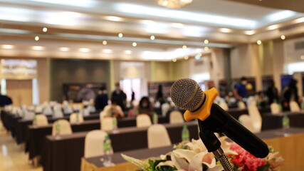 Close-up microphone on stand. Microphone on podium in the conference room for speaking or performing on stage on a blurry background with copy space. Selective focus