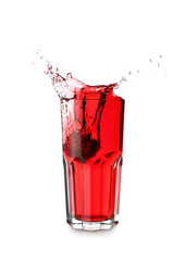 Glass of tasty pomegranate juice with splashes on white background