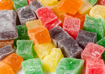 Appetizing cubes of colorful Turkish delight close up on a white background