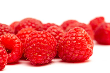 Closeup of red raspberries on a white background