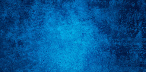Abstract Grunge Decorative Relief Navy Blue Stucco Wall Texture. Wide Angle Rough Colored Background With spot light.