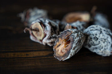 Dried persimmon on a wooden background. Healthy diet. High quality photo