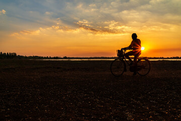 Fototapeta premium silhouette of people riding bicycles during sunset